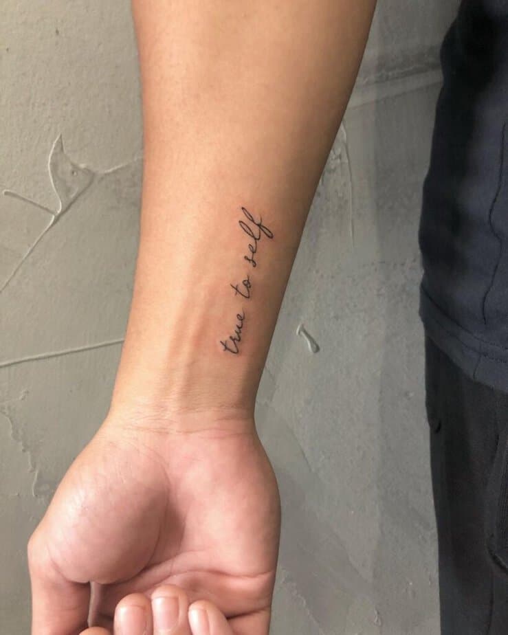 A script tattoo on the wrist