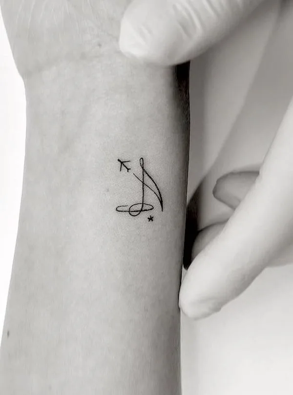 Music and plane small wrist tattoo