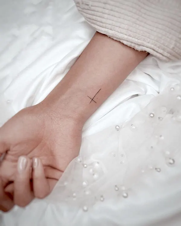 Simple cross wrist tattoo