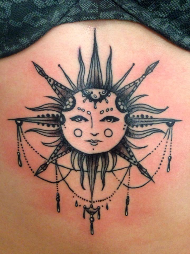 Artistic Sun Face Sternum Tattoo