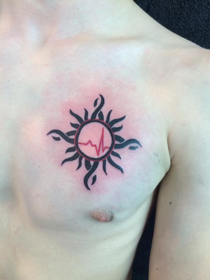 Unusual Tribal Sun with Heart Beat Tattoo