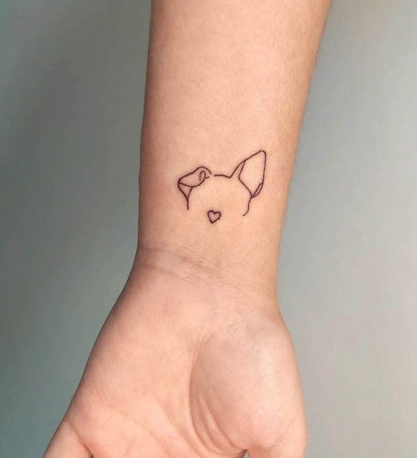 Dog ear outline wrist tattoo