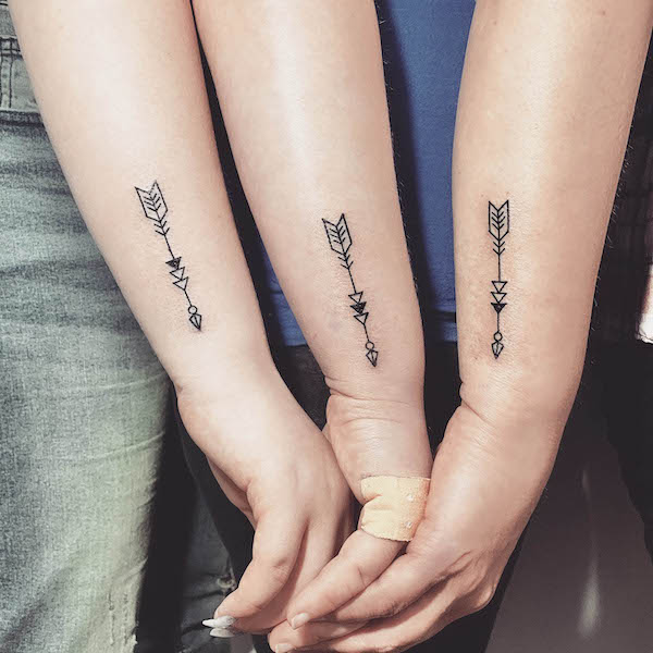 Matching mother-daughter arrow tattoos