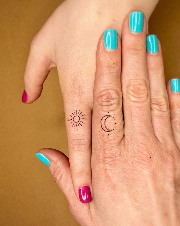 Matching sun and moon finger tattoos