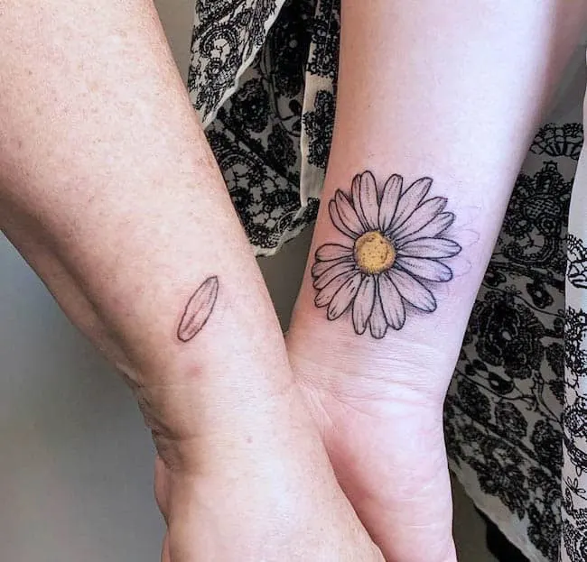 Sunflower and petal wrist tattoo