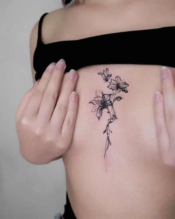 Abstract flowers sternum to chest tattoo