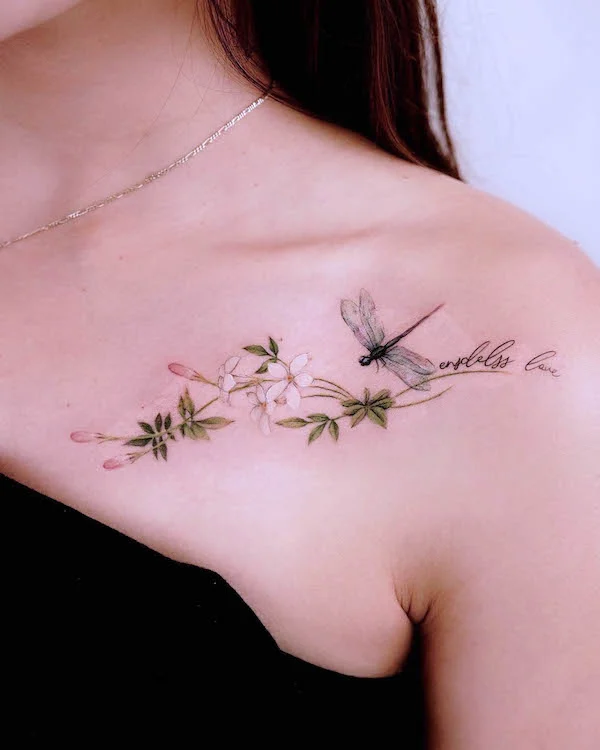 Feminine dragonfly chest tattoo