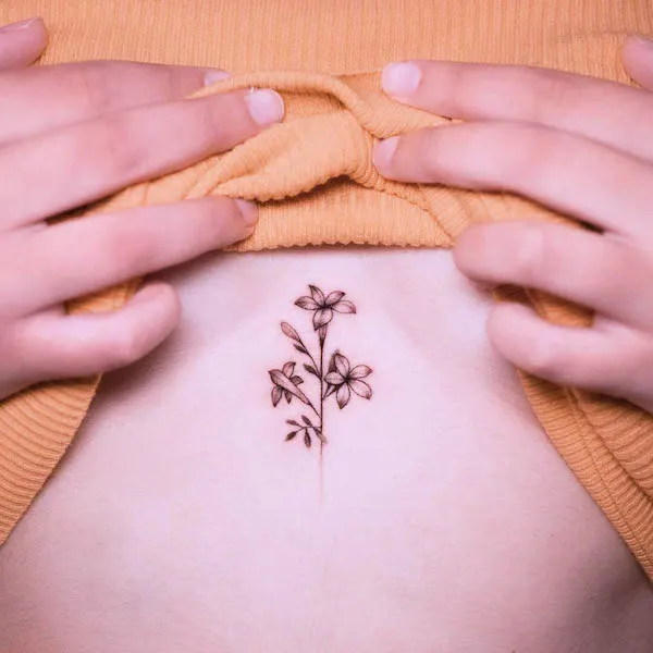 Small middle chest flower tattoo