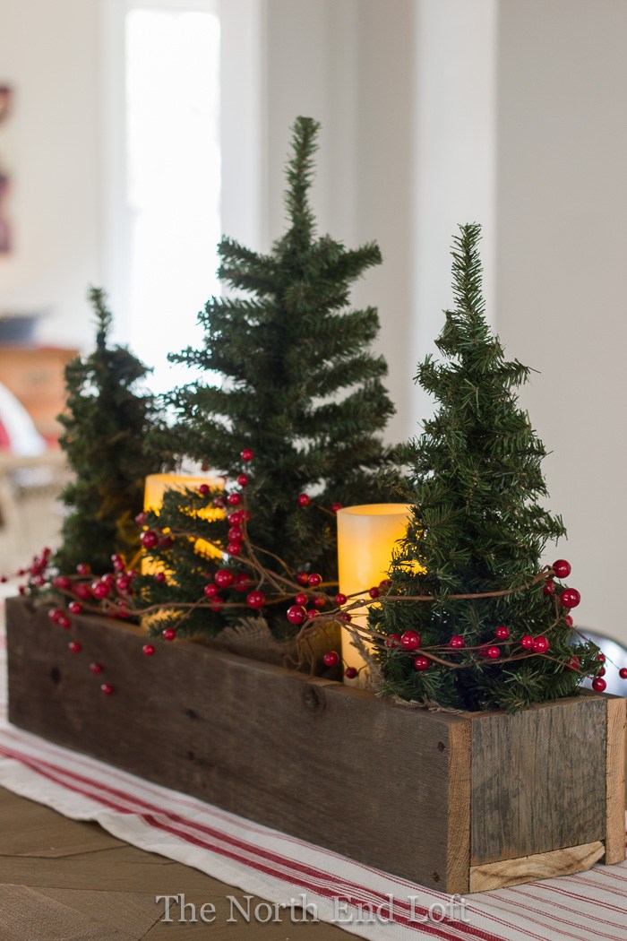 Rustic wood box, mini Christmas trees and candles.