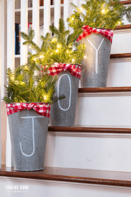 Stuff galvanized flower buckets with fresh pine.