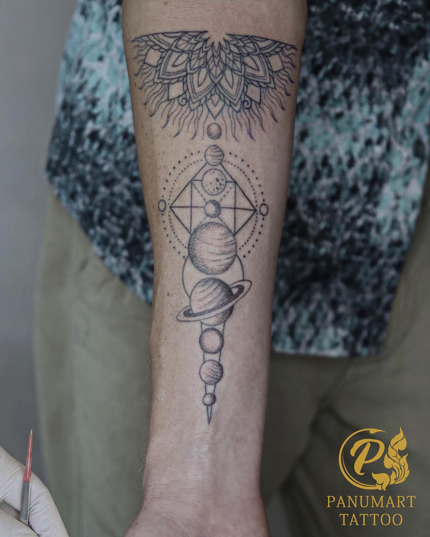 Forearm Tattoo of Mandala Sun and Planet