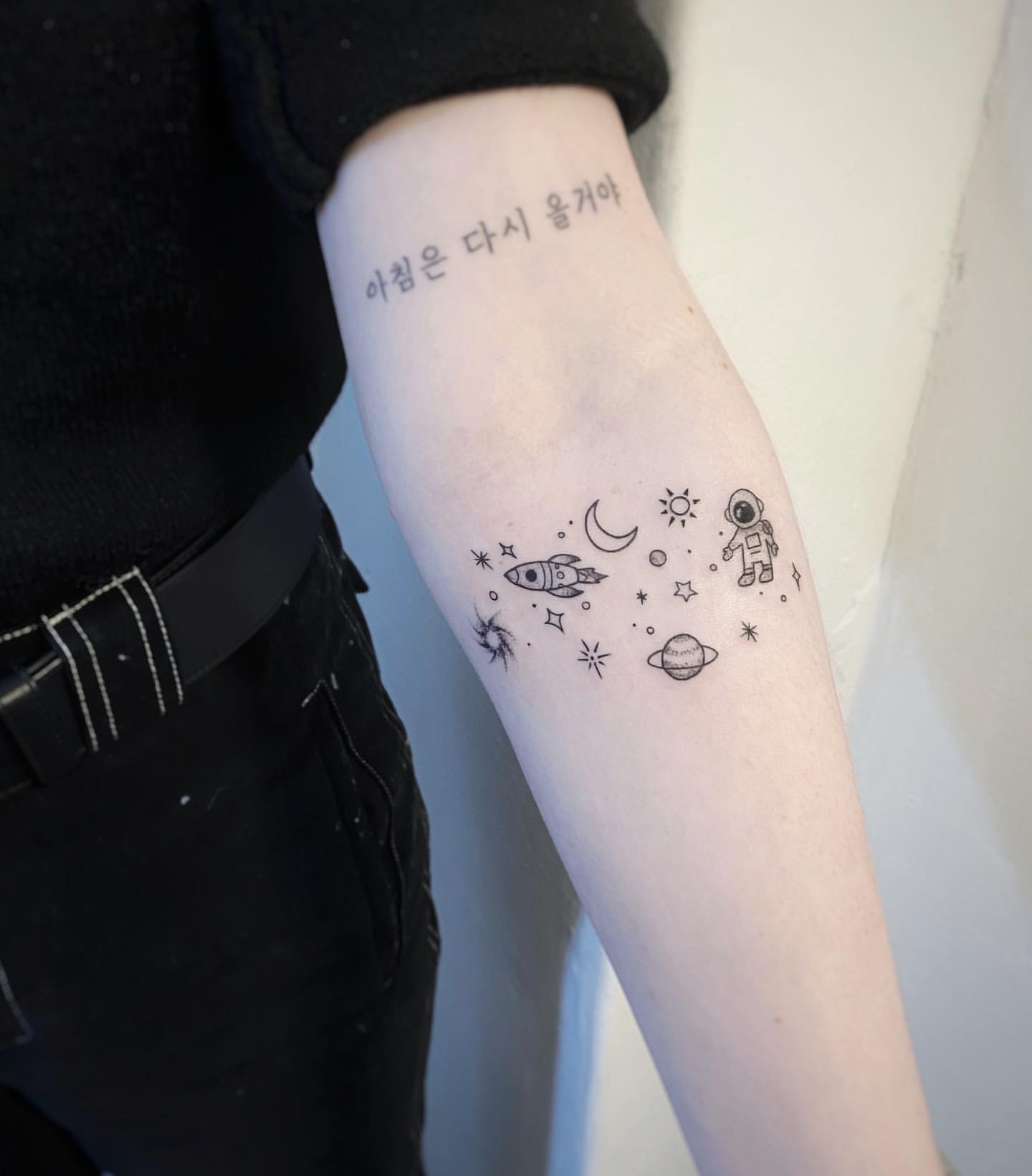 Minimal Linework Forearm Tattoo of Astronaut Floating Within the Galaxy