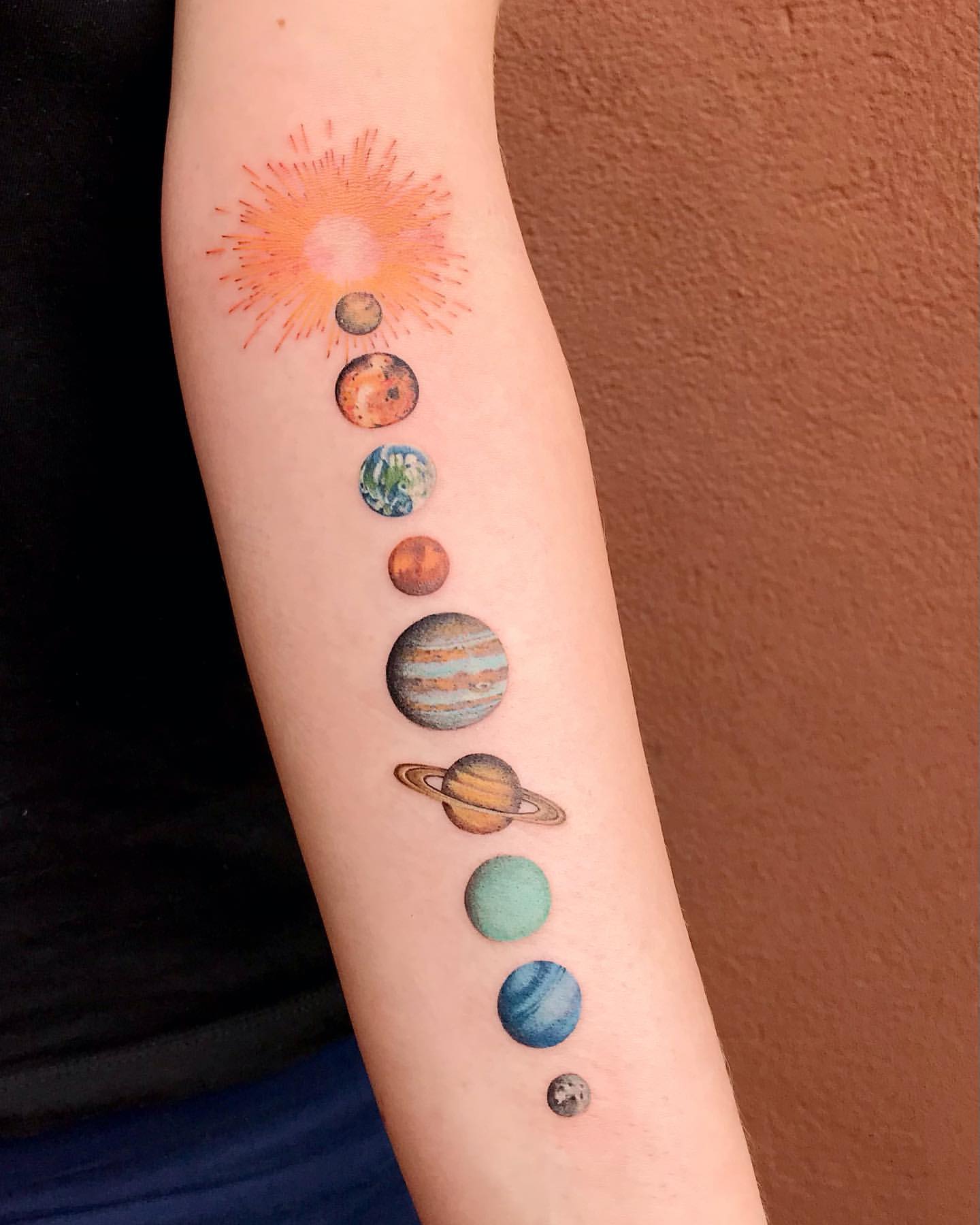 Minimal Realistic Tattoo of Planets on Forearm