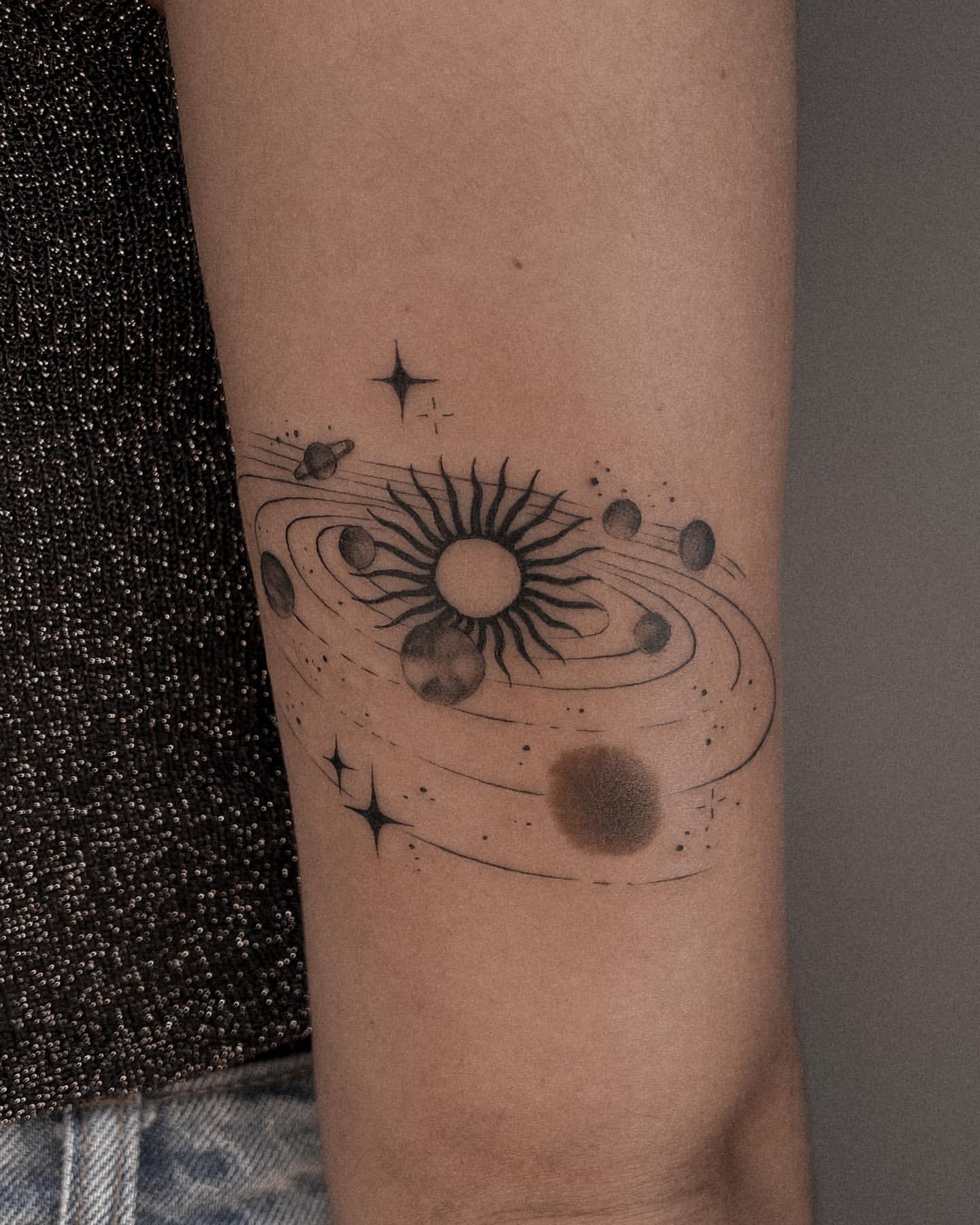 Minimal Tattoo of Solar System on Back of Arm