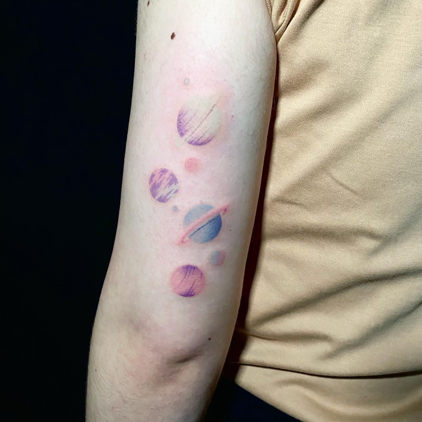 Watercolor Tattoo of Planets on Back of Arm