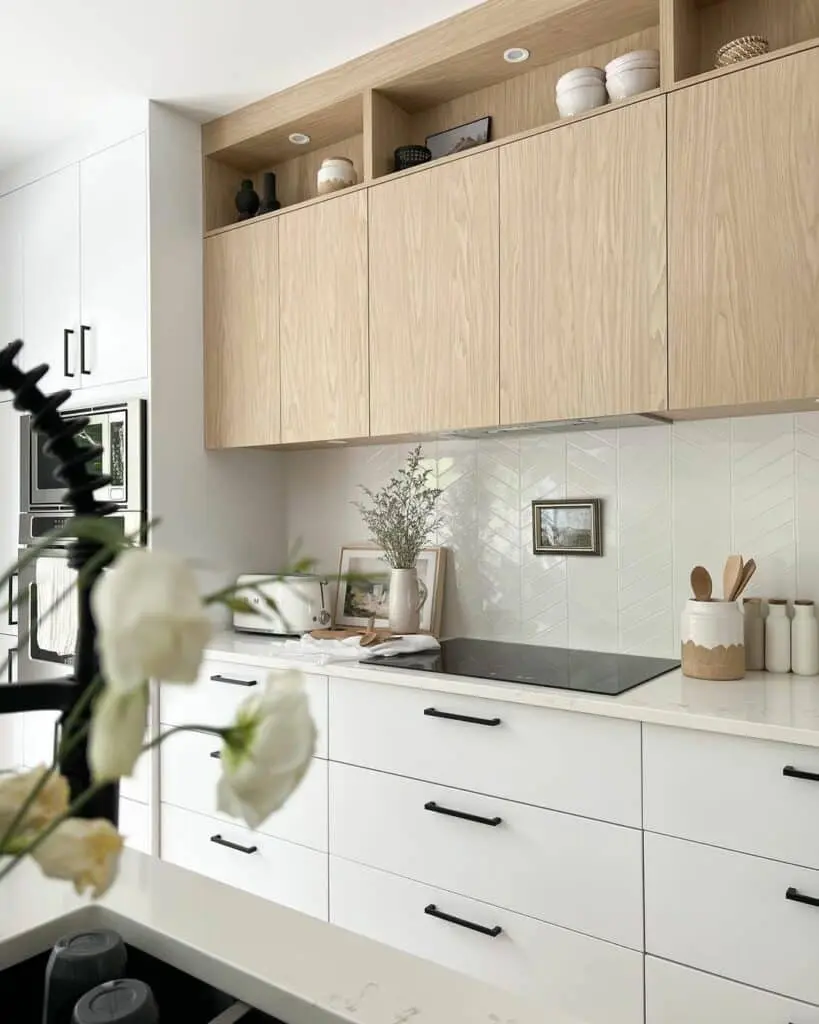 Light Wood Cabinets and a White Herringbone Backsplash