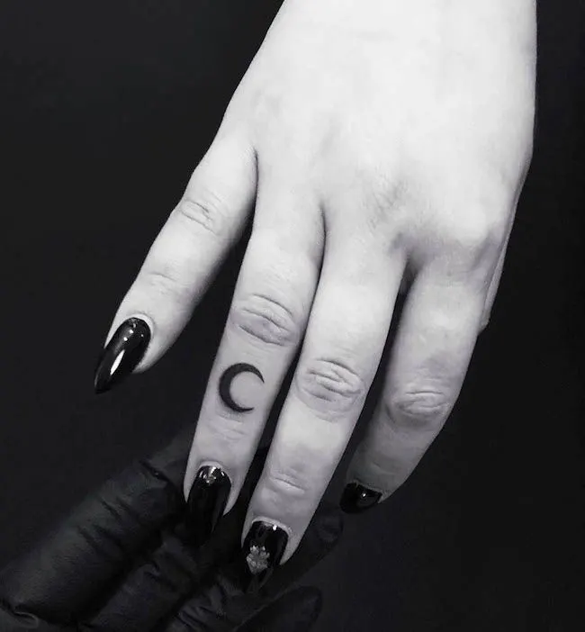 A crescent finger tattoo for women