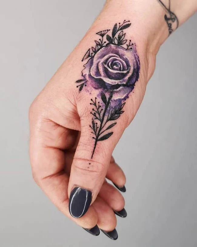 A realistic rose tattoo on the thumb