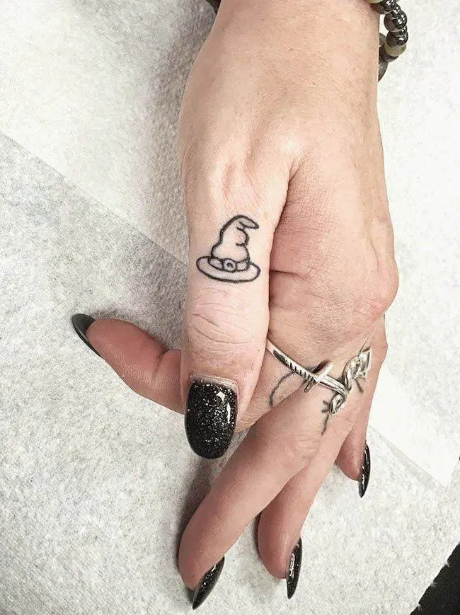 A witch hat thumb tattoo