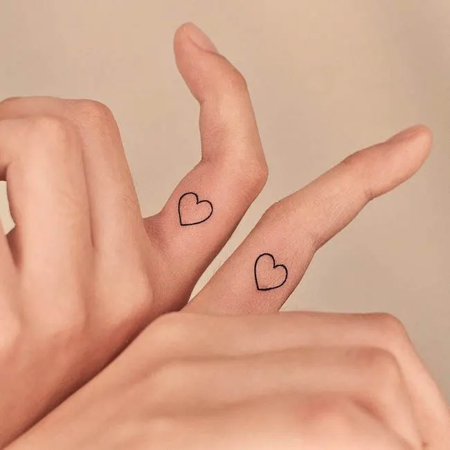 Cute heart inner finger tattoos