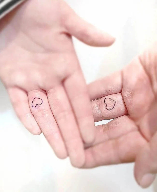 Small heart tattoos on the palm