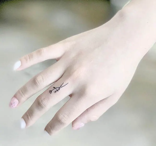 dainty floral finger tattoo