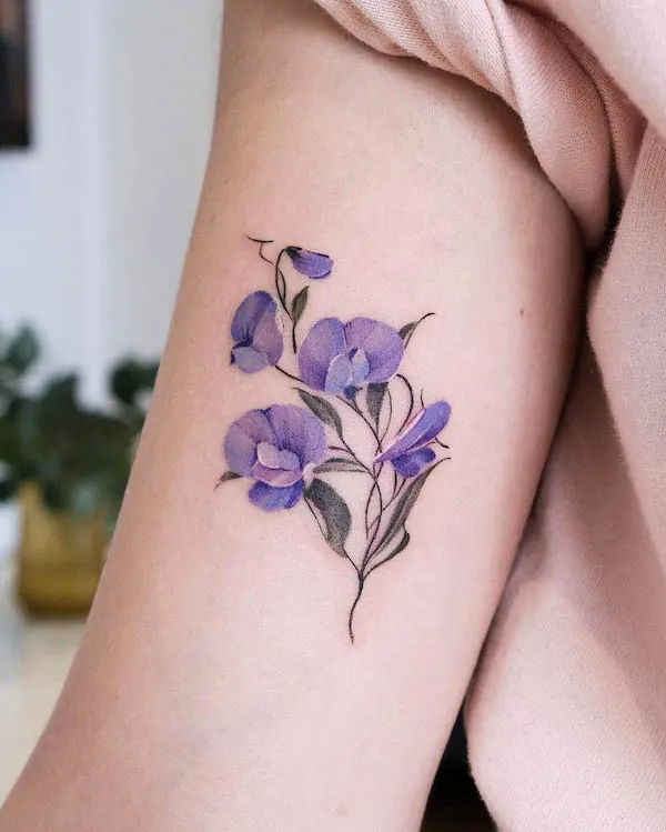 Blooming sweet pea arm tattoo