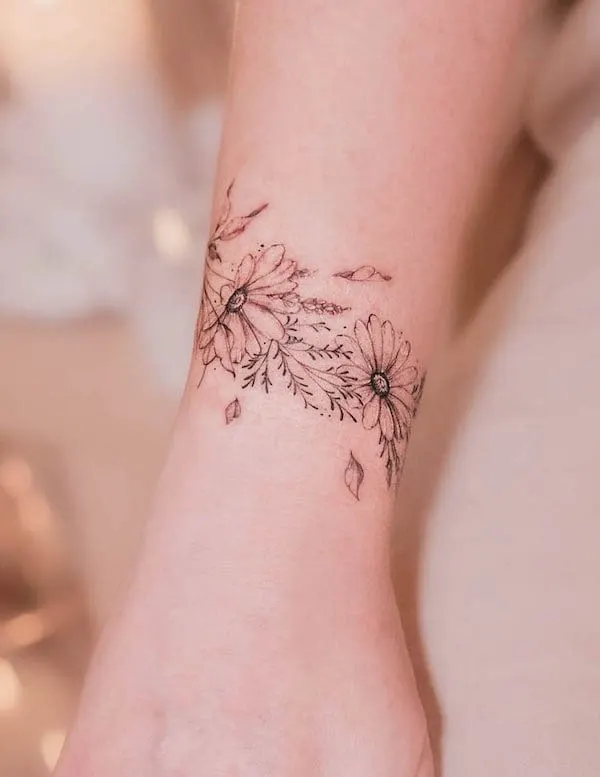 Daisy floral bracelet tattoo