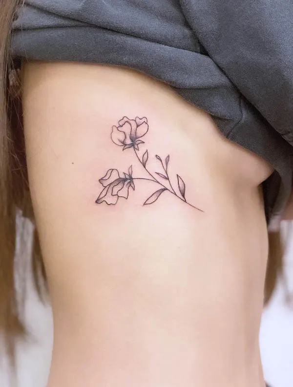 Minimalist sweet pea rib tattoo
