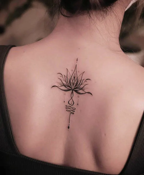 Symbolic water lily back tattoo
