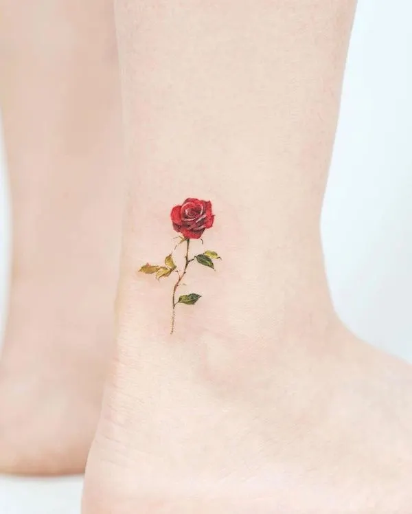 Tiny red rose ankle tattoo
