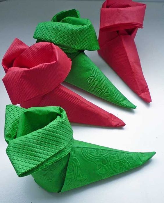 Adorable little pointed elf shoes shape napkin folding idea.