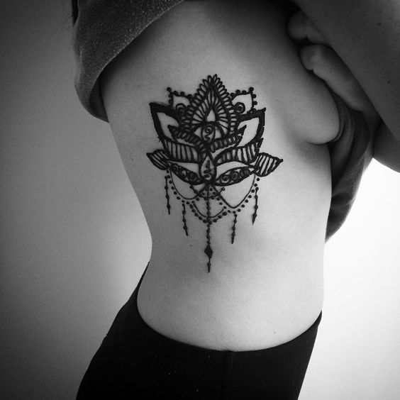 Attractive lotus flower rib tattoo design for girls