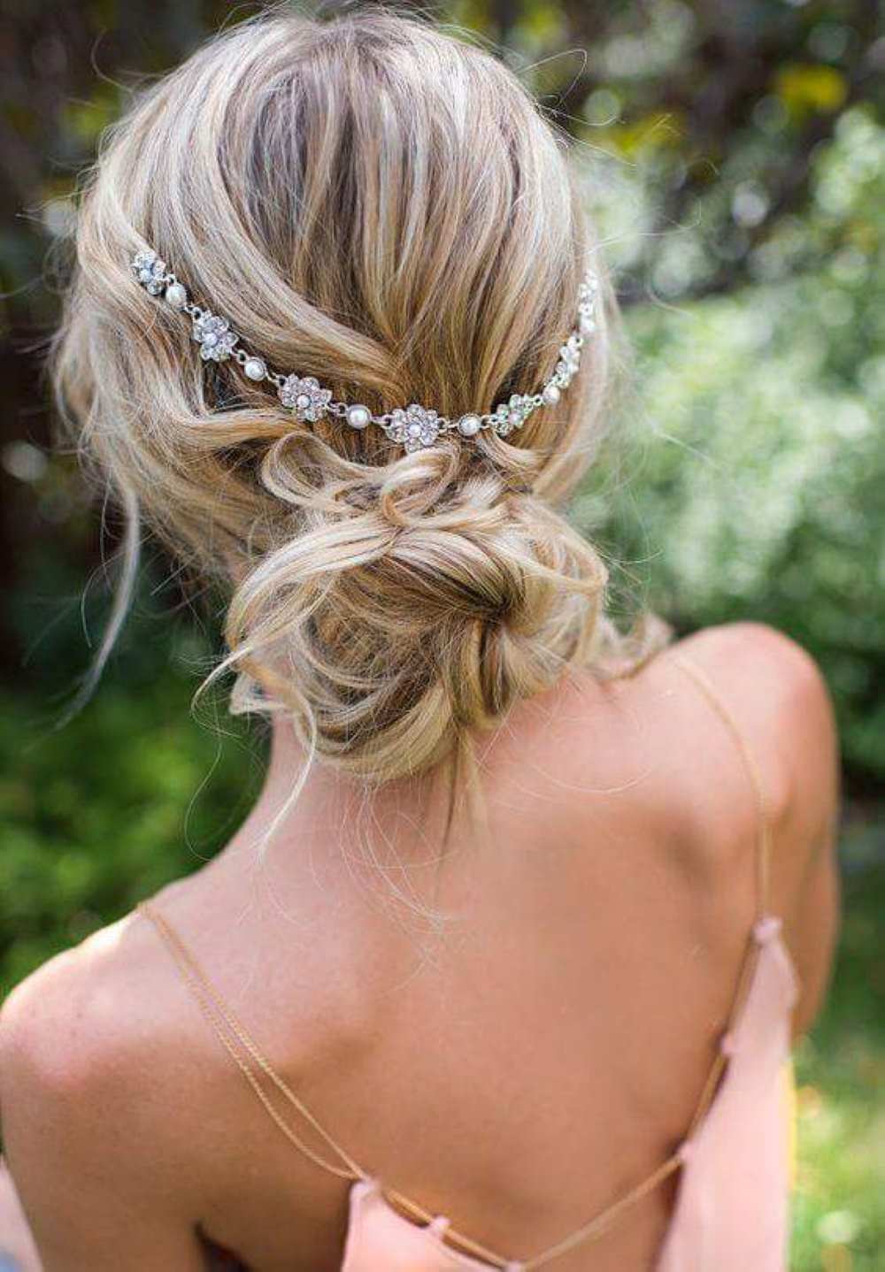 Interesting twisted low bun for Boho weddings