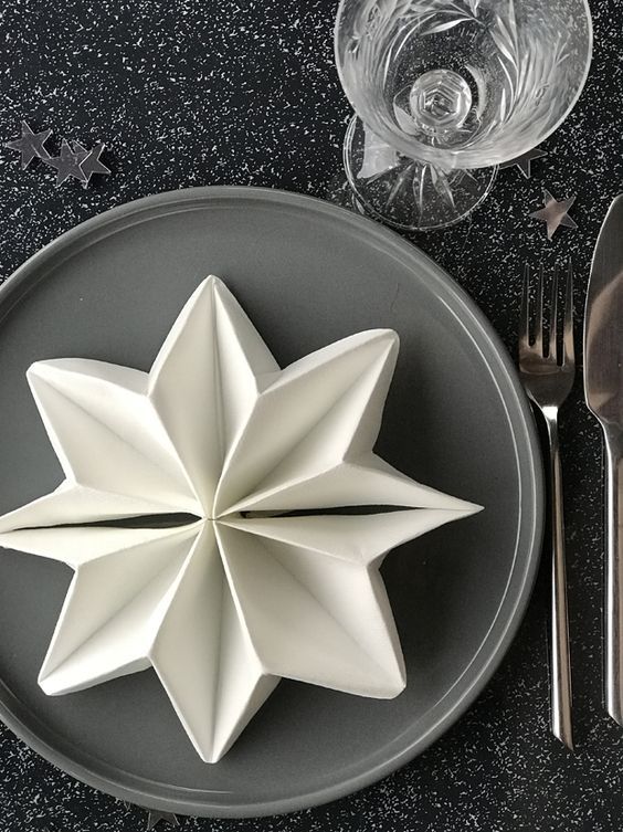 Snowflake napkin folding for Christmas dinner.