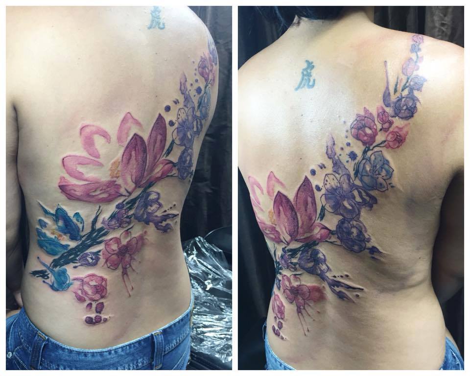 Watercolour cherry blossoms and lotus flowers tattoo