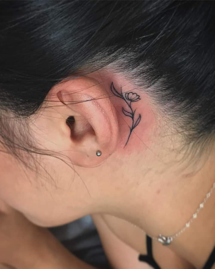 Beautiful and Girly Blooming Flower on a Delicate Stem Ear Tattoo