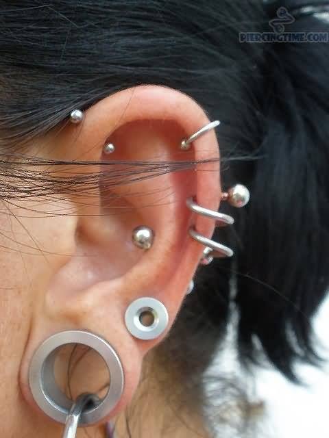 Left Ear Stretched Lobe and Spiral Cartilage Piercing