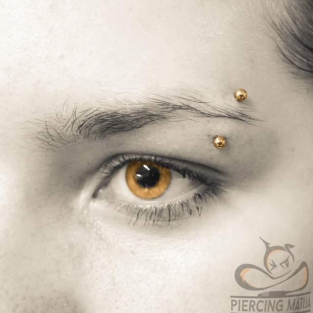 Unique Yellow Eyes with Brow Piercing