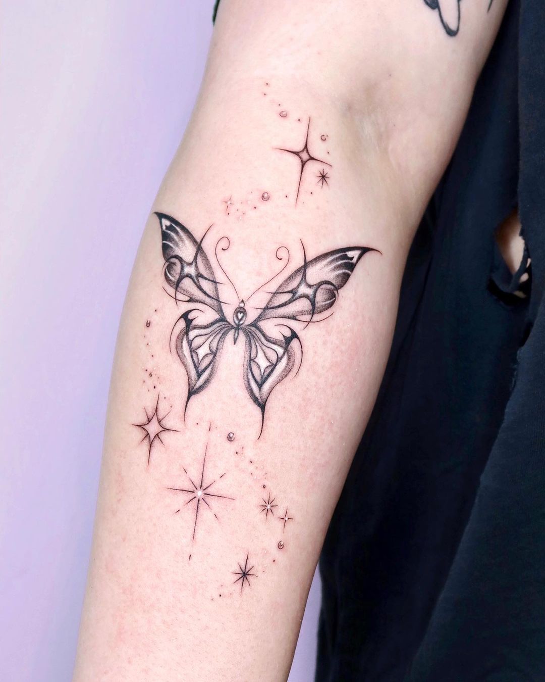 Butterfly Tattoo on Forearm with Stars