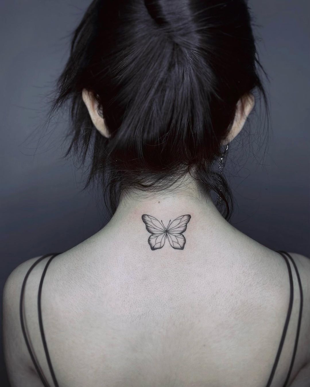 Minimalist Butterfly Tattoo on the Neck