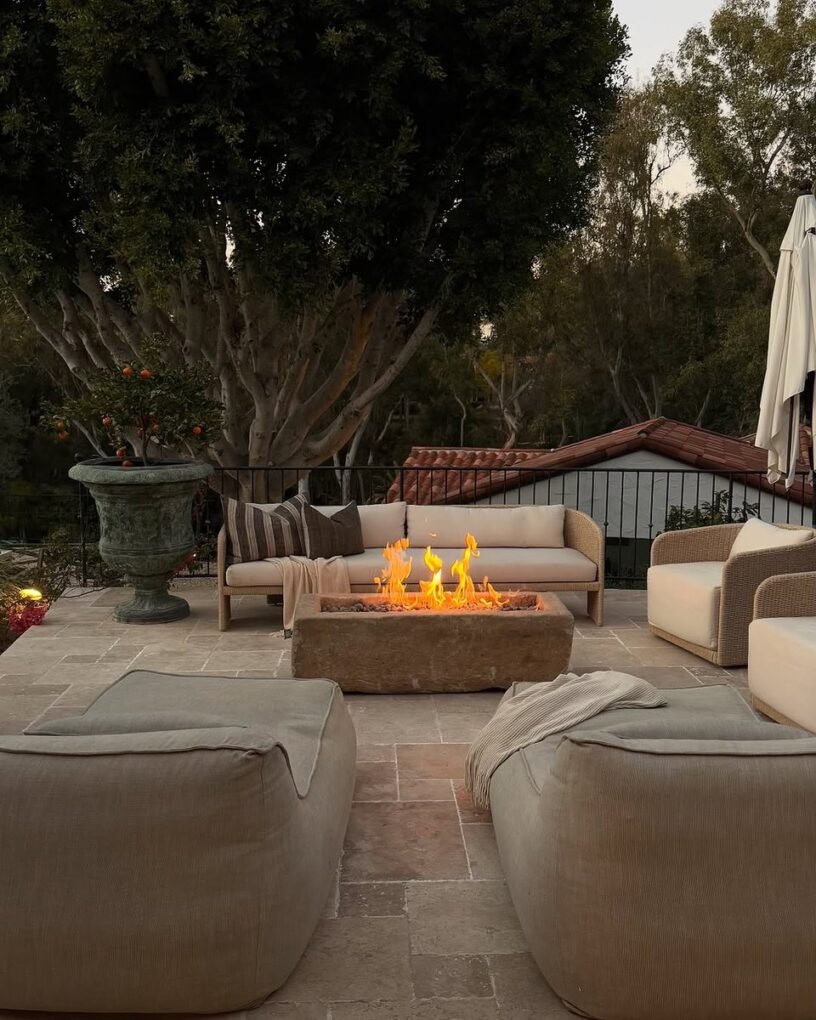 20 Modern Outdoor Fire Pit Ideas: Sleek Designs for Any Home 9 Fire Pit Surrounded by Potted Plants
