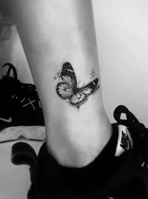 Black butterfly ankle tattoo