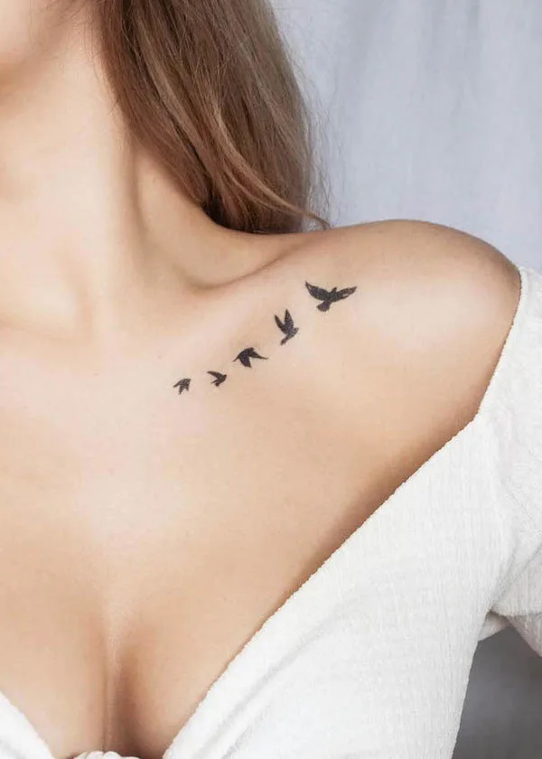 Flying birds collarbone tattoo