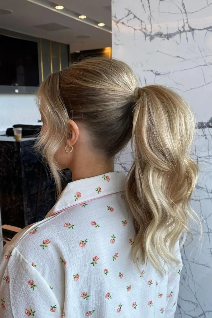 Sleek and Stylish: 20 Low Ponytail Hairstyles You’ll Love 9 Softly Curled Blonde Low Ponytail