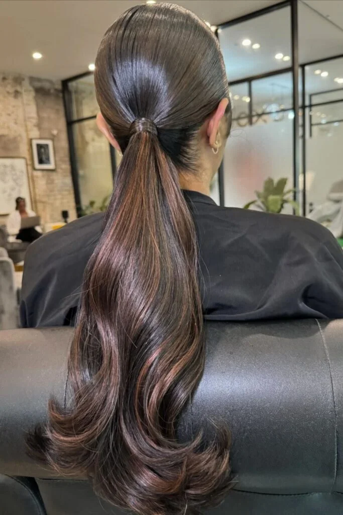 Sleek and Stylish: 20 Low Ponytail Hairstyles You’ll Love 2 Voluminous Curled Low Ponytail